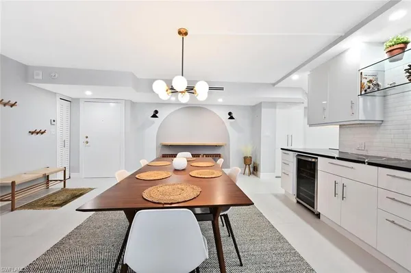 a kitchen with stainless steel appliances a table chairs and stove