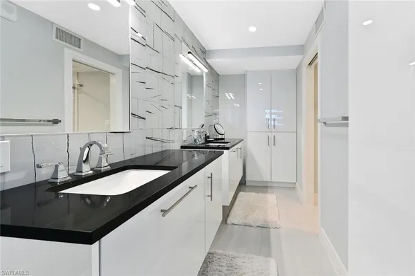 a bathroom with a sink a double vanity and a mirror