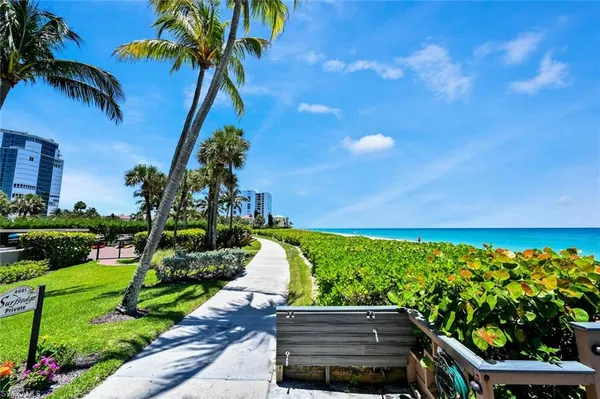 a backyard of a house with lots of green space and lake view