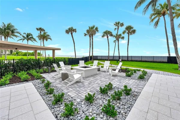 a row of palm trees and swimming pool in the garden