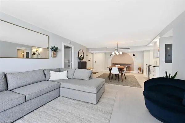 a living room with furniture and a chandelier