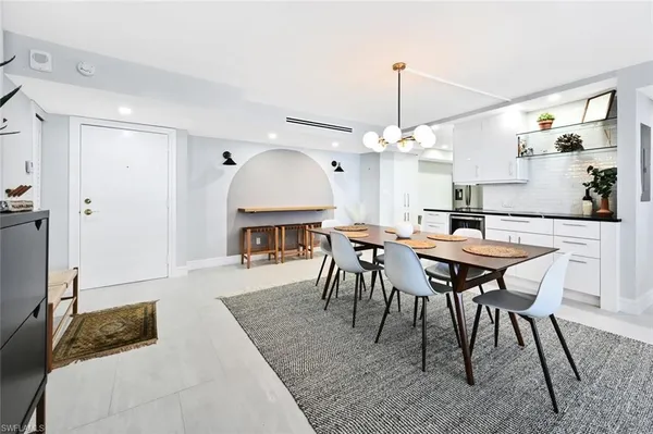 a view of a a dining room with furniture window and wooden floor