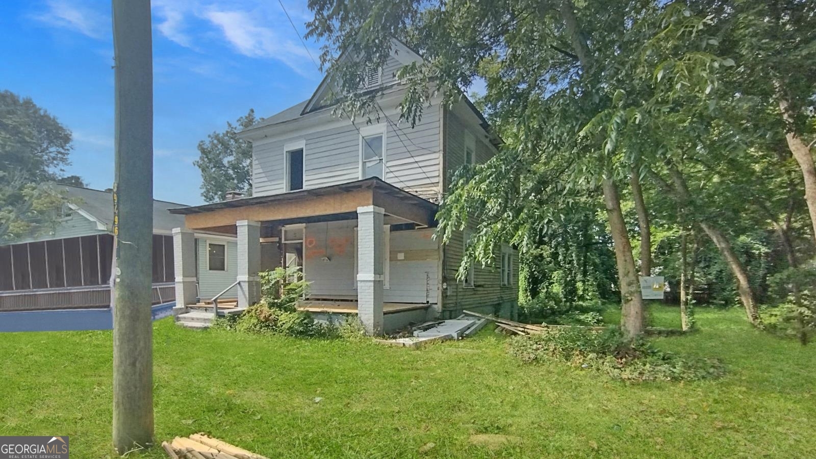a view of a house with backyard and a tree