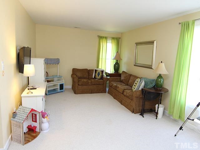 1508 Wood Spring Court Raleigh, NC 27614 - Photo 14 of 25 a living room with furniture and a window