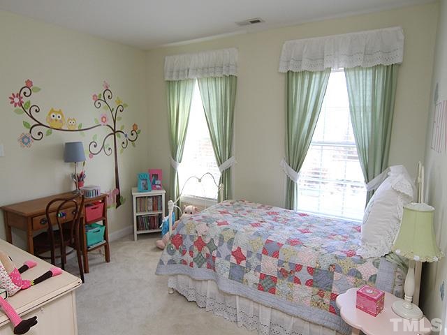 1508 Wood Spring Court Raleigh, NC 27614 - Photo 17 of 25 a bedroom with a bed and a chandelier