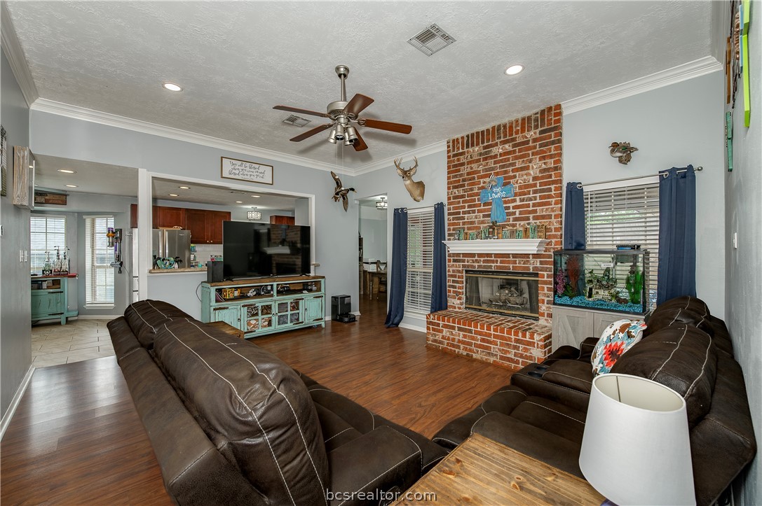 2009 Cobblestone Lane Bryan, TX 77807 - Photo 6 of 23 a living room with fireplace furniture and a flat screen tv