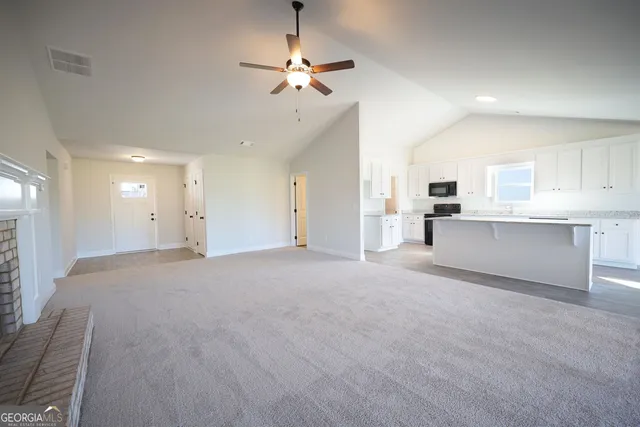 a view of a kitchen with furniture and a ceiling fan