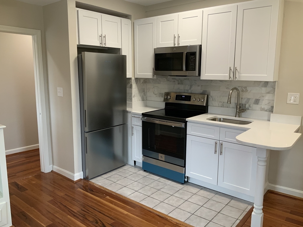 a kitchen with a sink stainless steel appliances and cabinets