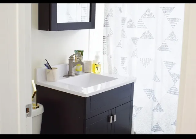 a bathroom with a sink vanity and a mirror