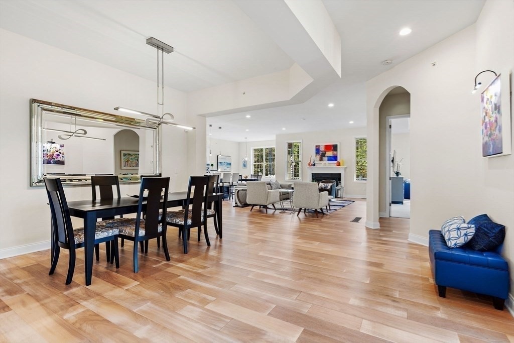 61 Ridgewood Drive Stow, MA 01775 - Photo 15 of 31 a view of a dining room and livingroom with furniture wooden floor a chandelier
