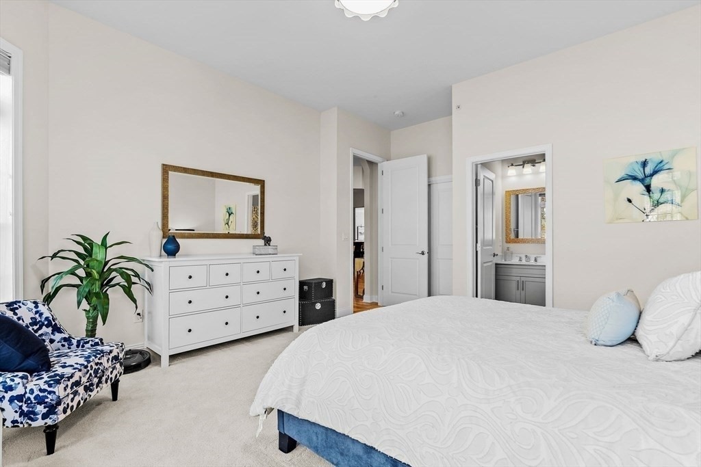 61 Ridgewood Drive Stow, MA 01775 - Photo 23 of 31 a bedroom with a bed plant and dresser
