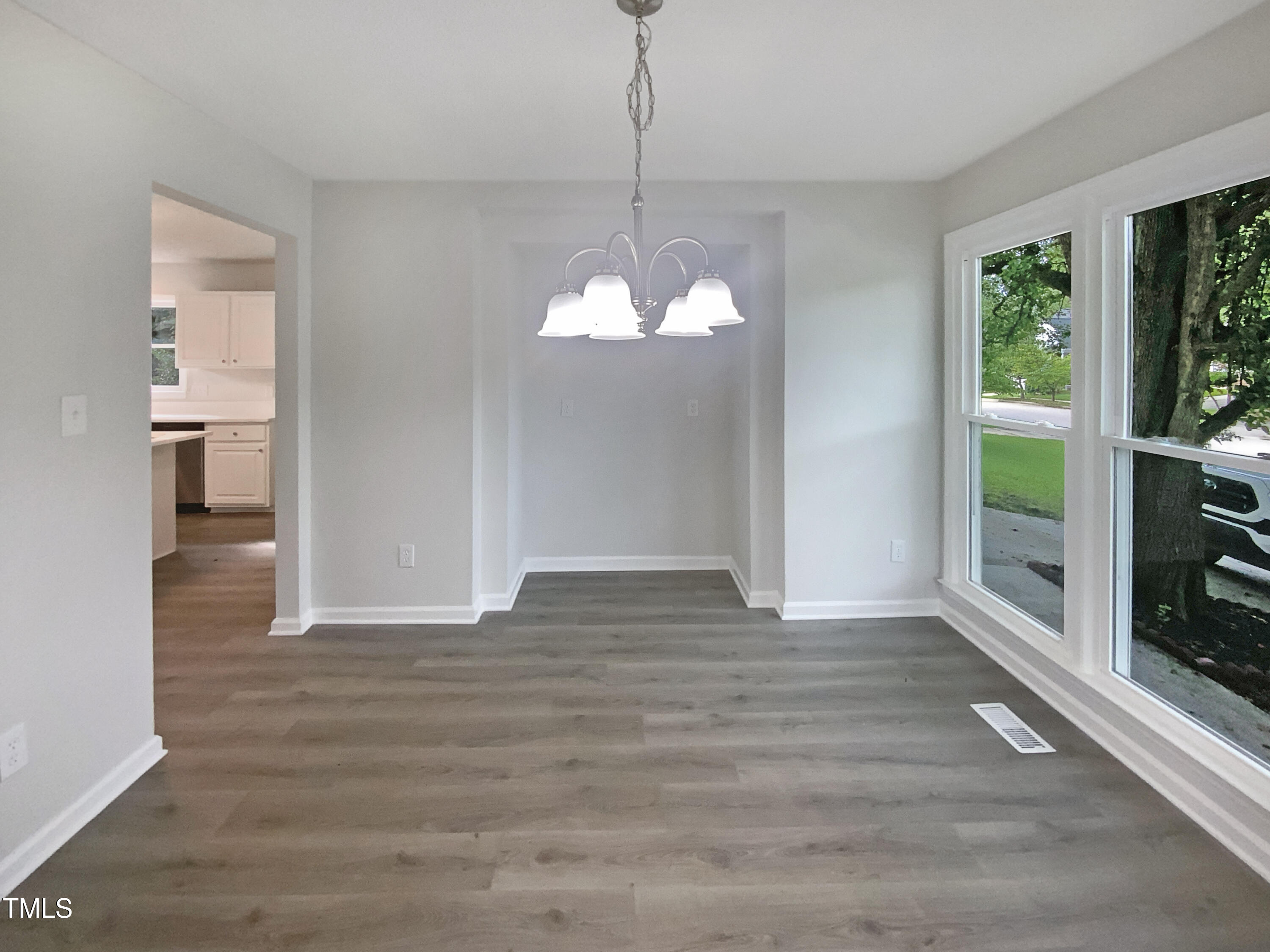 2301 Declaration Drive Raleigh, NC 27615 - Photo 12 of 19 a view of a room with wooden floor chandeliers and kitchen view