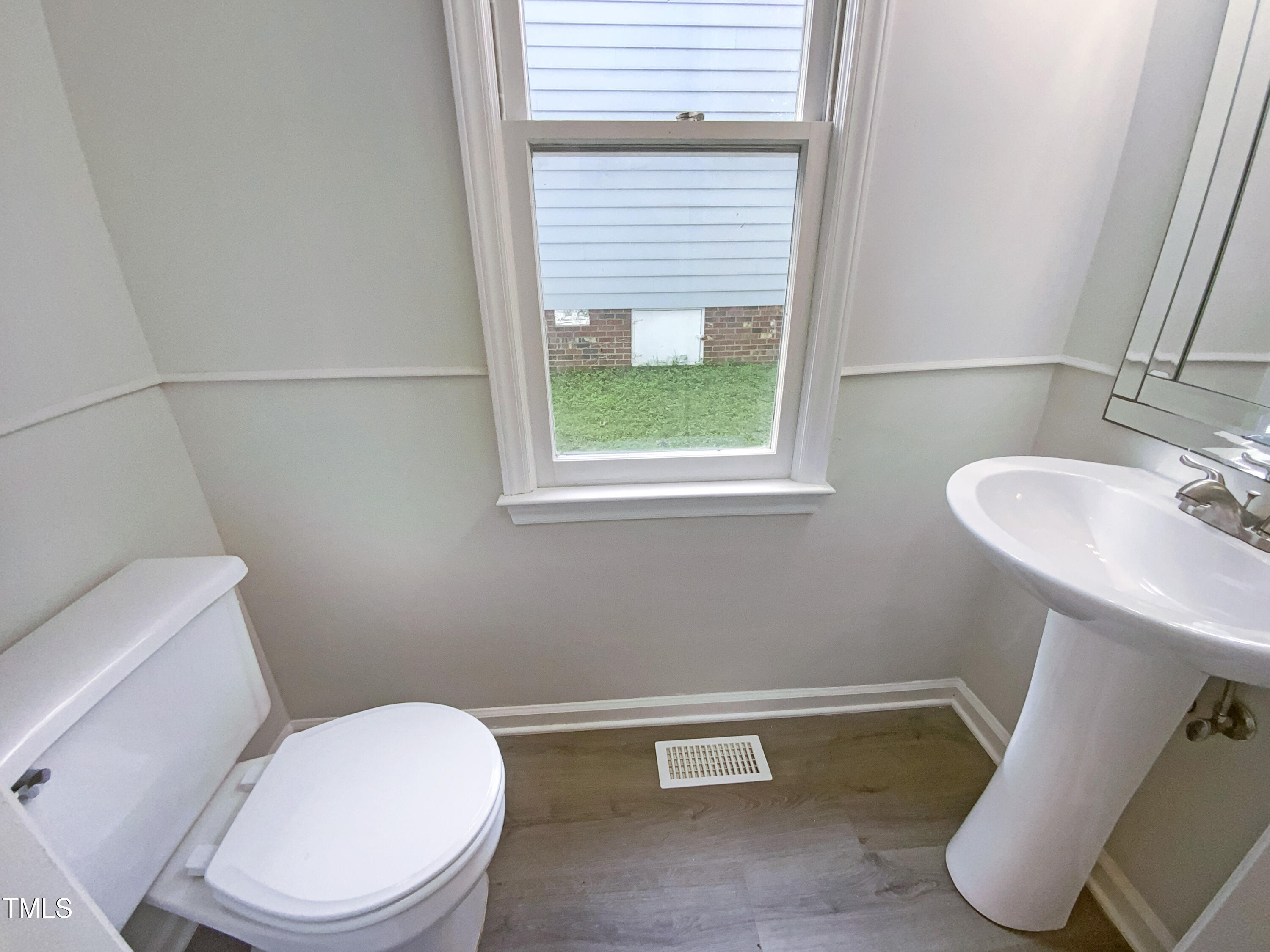 2301 Declaration Drive Raleigh, NC 27615 - Photo 13 of 19 a white toilet sitting next to a bathroom sink