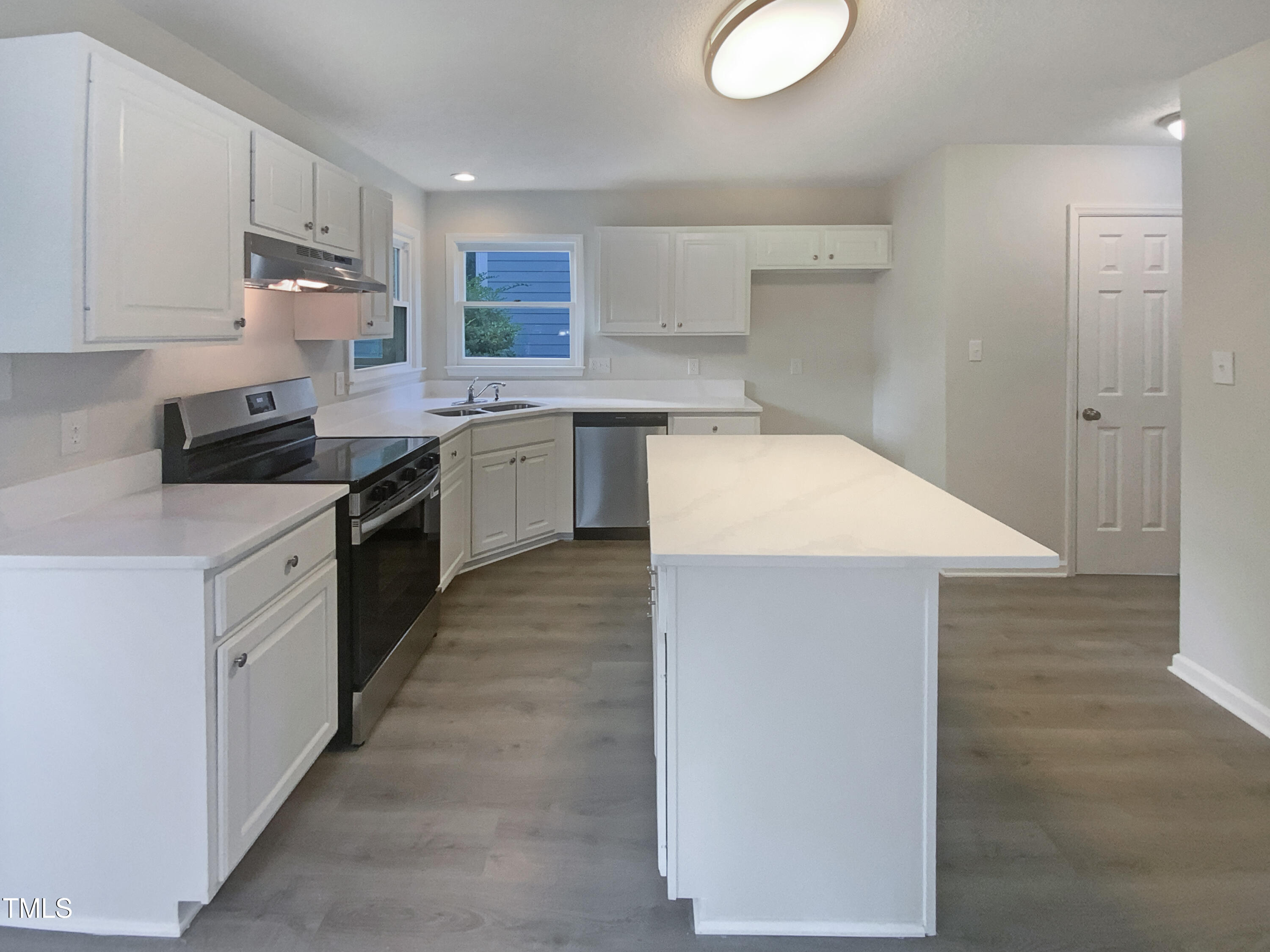 2301 Declaration Drive Raleigh, NC 27615 - Photo 6 of 19 a kitchen with a sink stove and cabinets