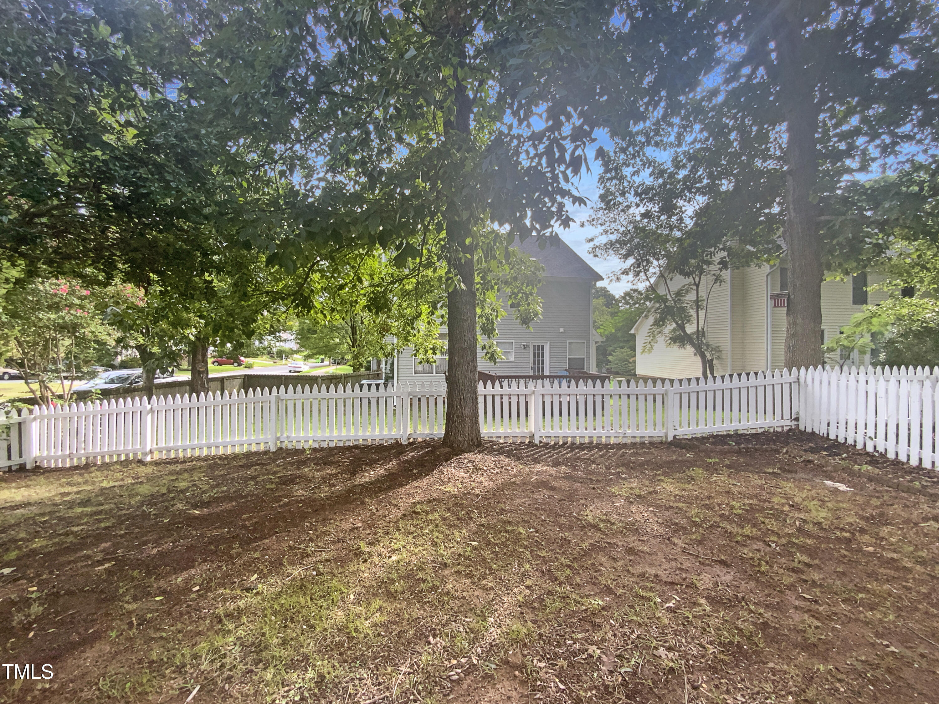 2301 Declaration Drive Raleigh, NC 27615 - Photo 9 of 19 a view of a yard with large trees and wooden fence