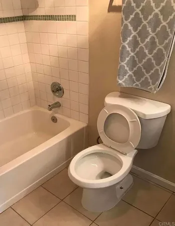 a bathroom with a toilet and a bathtub