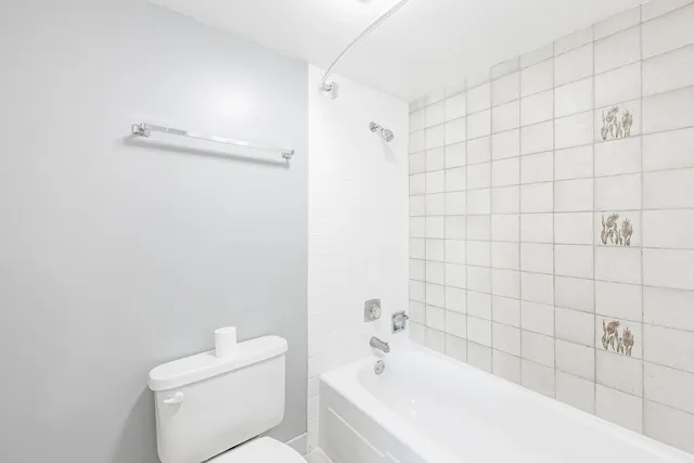 a white bath tub sitting next to a white toilet