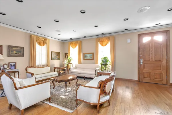 a living room with fireplace furniture and a large window