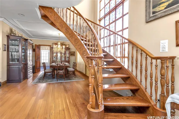 a view of entryway and hall with wooden floor