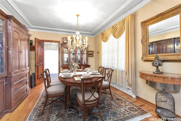 a dining room with furniture a chandelier and wooden floor