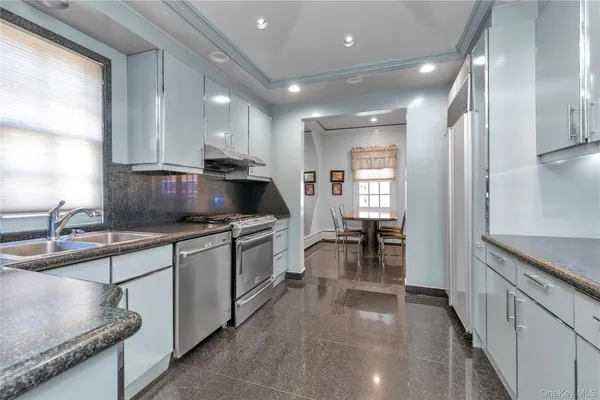 a kitchen with sink cabinets and stove