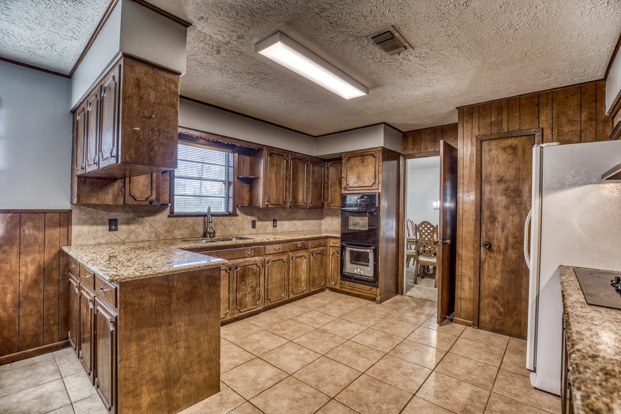 1687 Eagle Lake Road Sealy, TX 77474 - Photo 10 of 27 a kitchen with stainless steel appliances granite countertop a sink stove and refrigerator