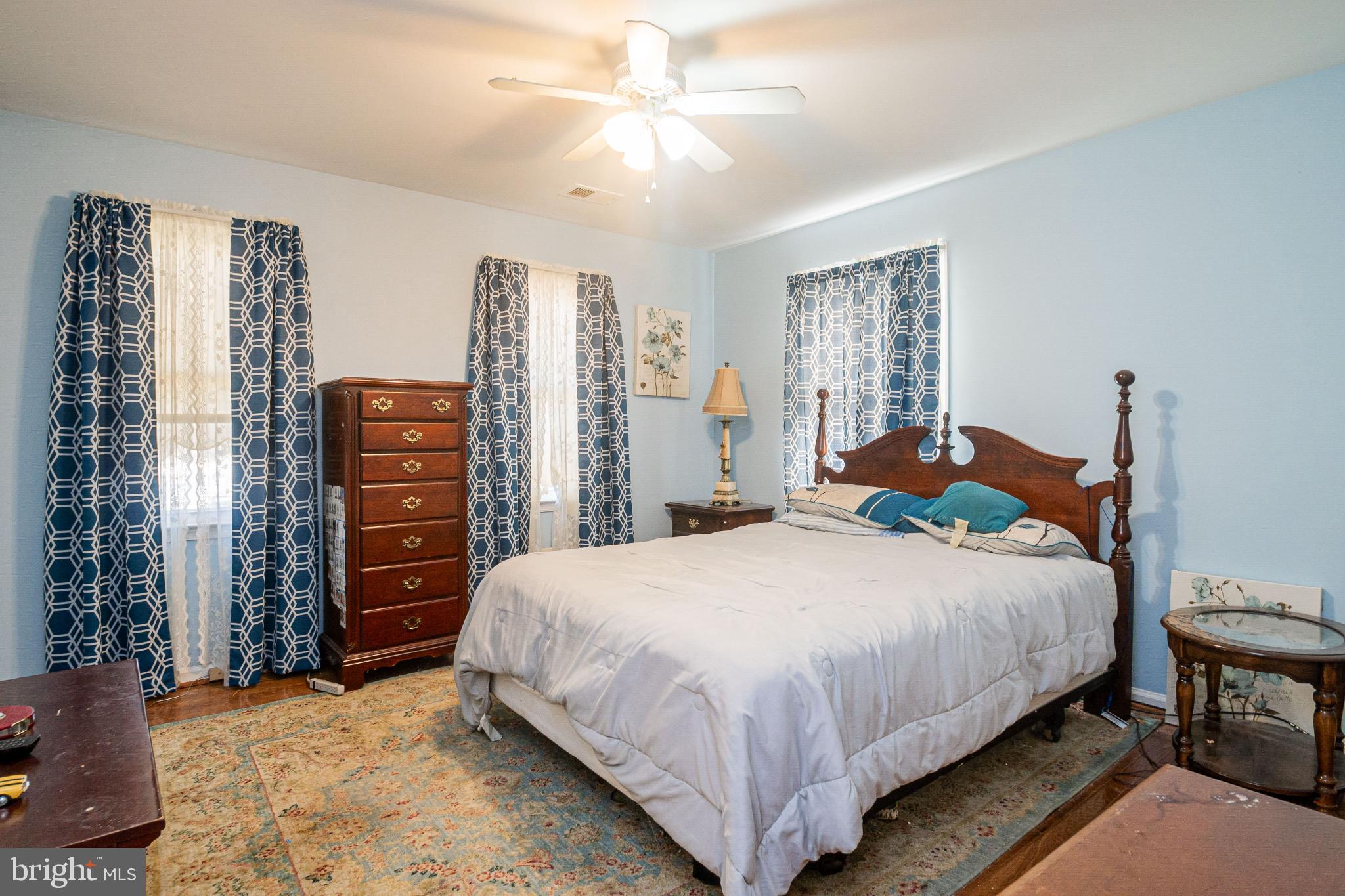 4910 Grid Street Bowie, MD 20720 - Photo 18 of 29 a bedroom with a bed and a chandelier