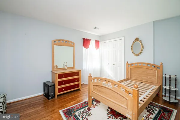 a bedroom with a bed and a dresser