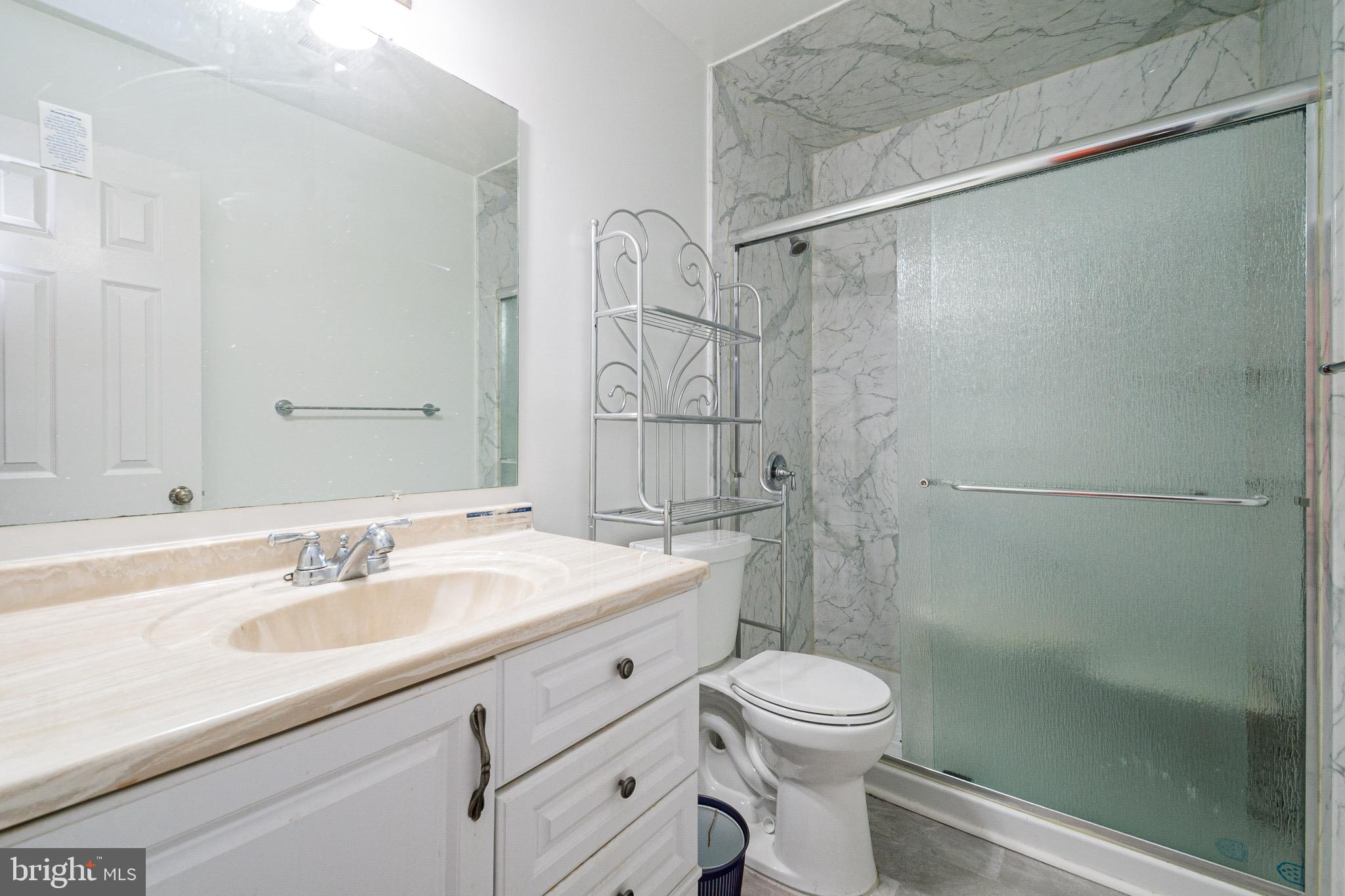 4910 Grid Street Bowie, MD 20720 - Photo 21 of 29 a bathroom with a sink a toilet and shower