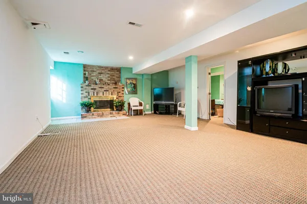 a view of a livingroom with furniture and a flat screen tv