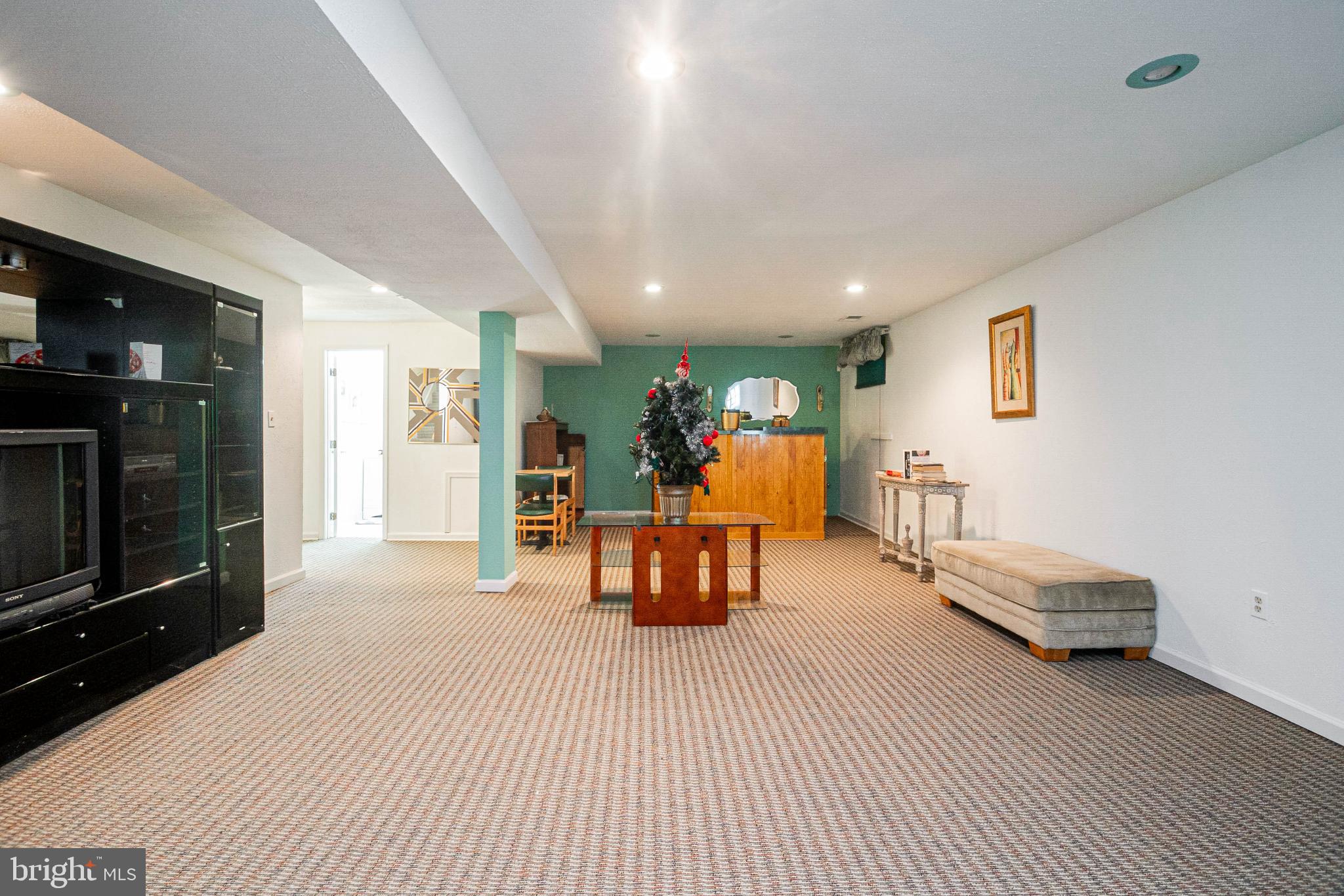 4910 Grid Street Bowie, MD 20720 - Photo 23 of 29 a living room with furniture and a flat screen tv