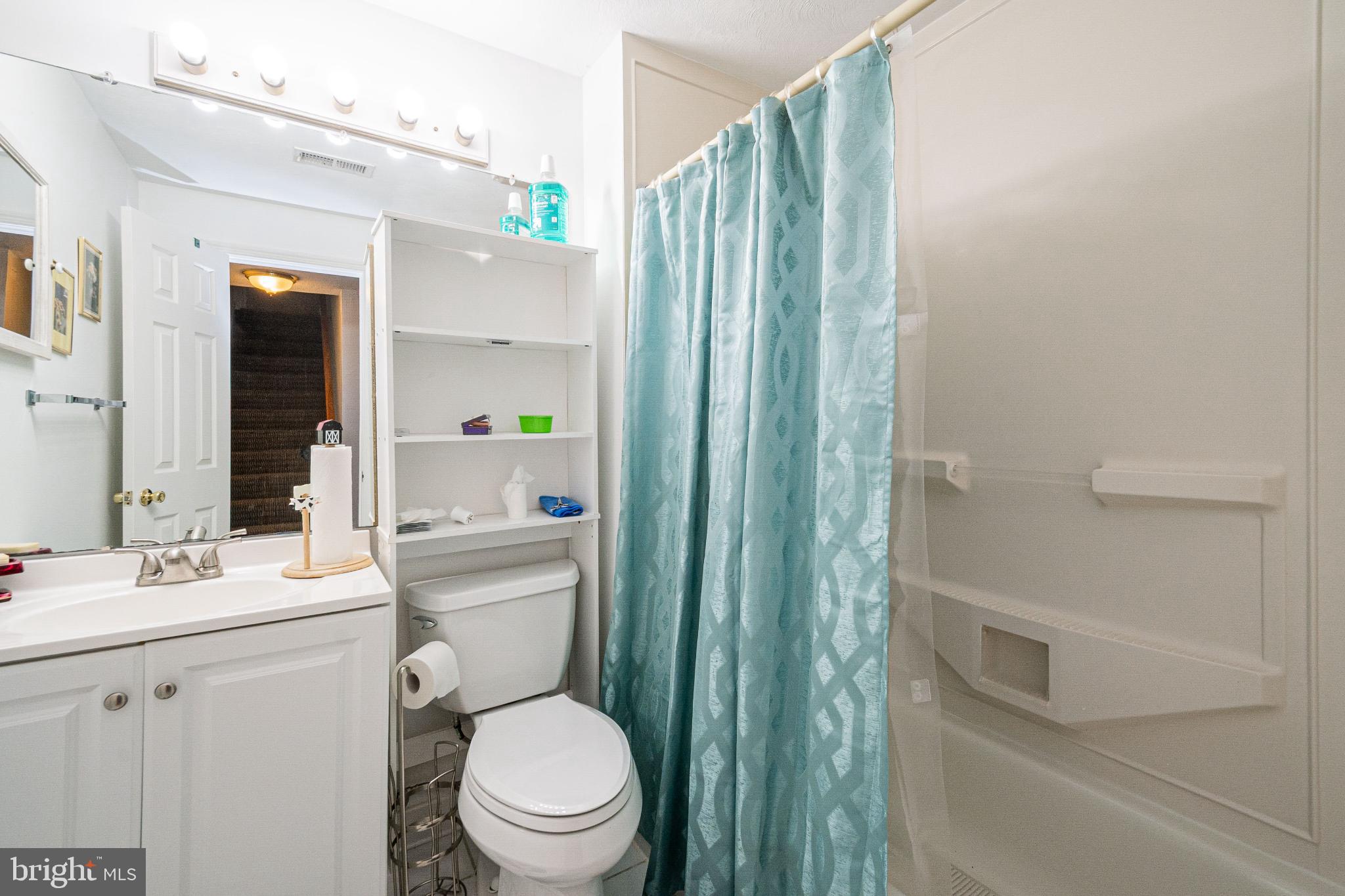 4910 Grid Street Bowie, MD 20720 - Photo 24 of 29 a bathroom with a toilet a sink and a mirror