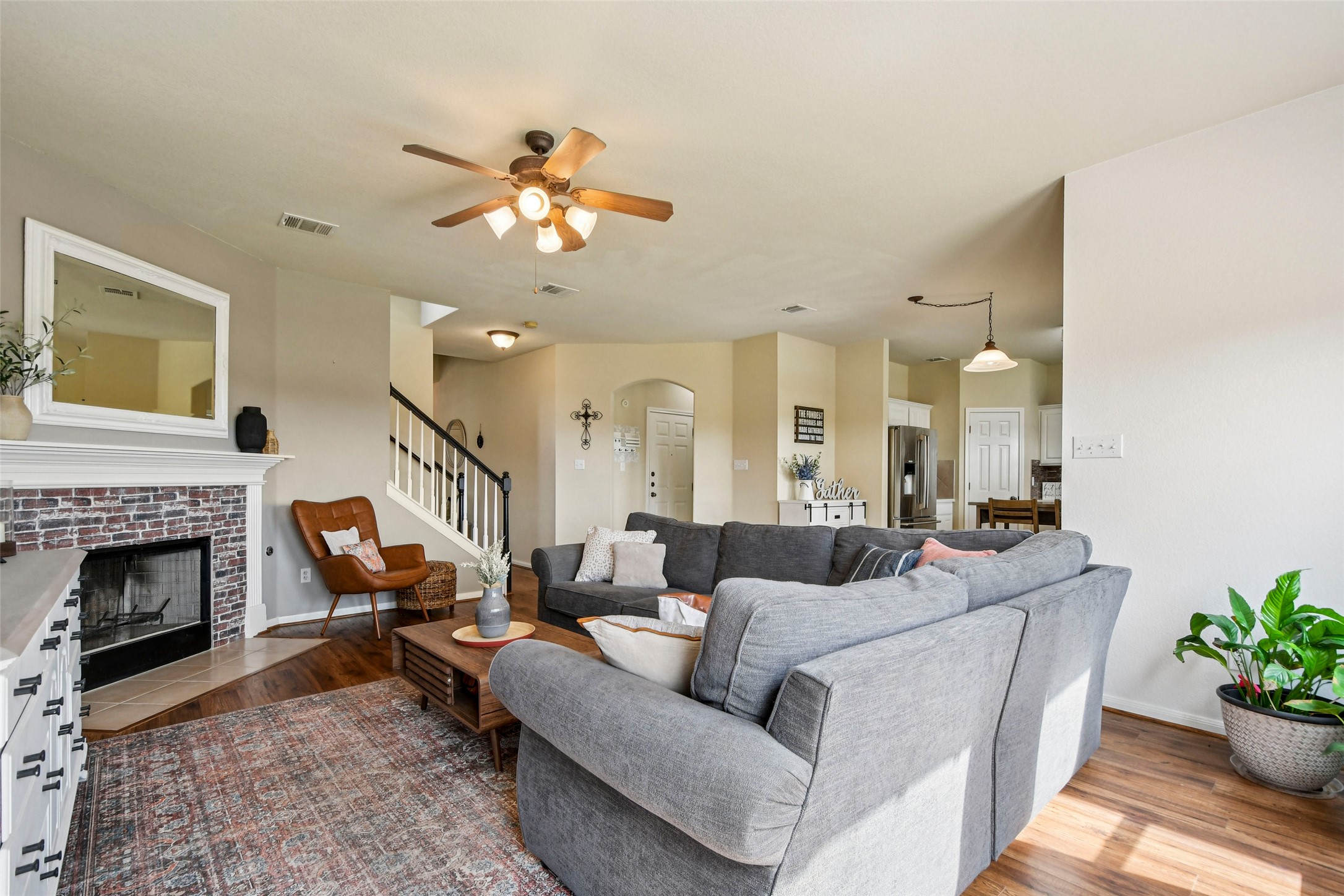 410 Rosedale Boulevard Georgetown, TX 78628 - Photo 3 of 34 Light-filled living room with fireplace and open flow to the kitchen
