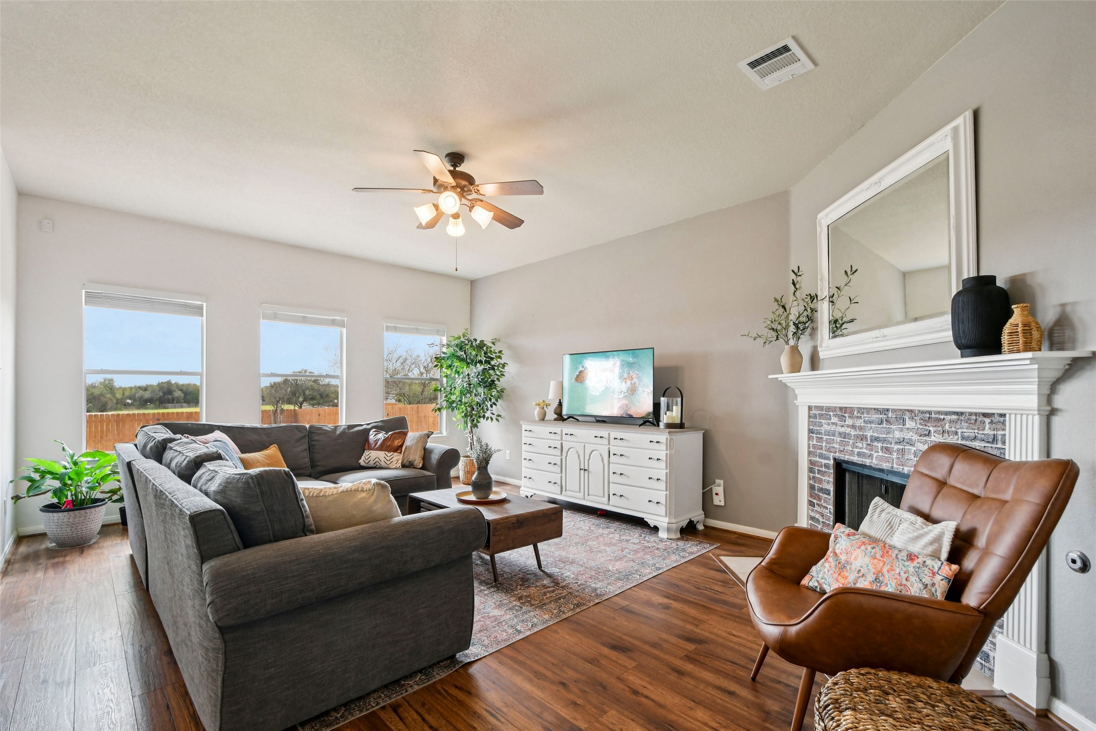 410 Rosedale Boulevard Georgetown, TX 78628 - Photo 4 of 34 Comfortable gathering space anchored by a cozy fireplace