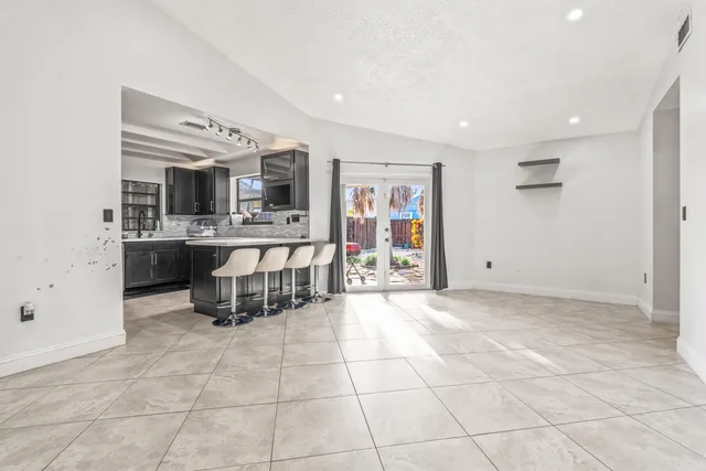 a view of a hallway with wooden floor and a kitchen