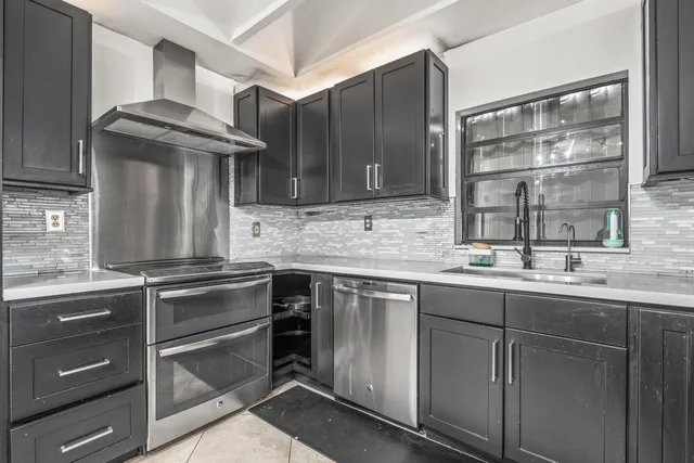 a kitchen with stainless steel appliances granite countertop a sink stove and refrigerator