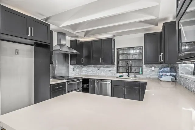 a kitchen with a sink cabinets and window