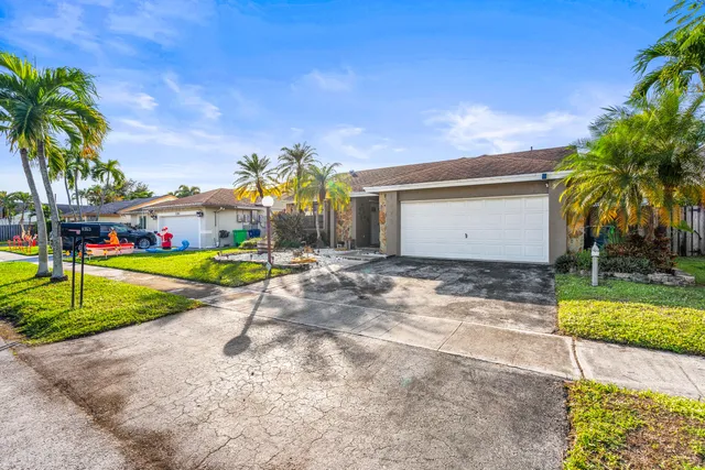 a view of a house with entertaining space and palm trees