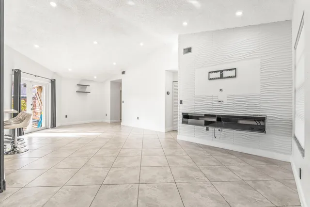 a living room with stainless steel appliances kitchen island granite countertop furniture and a view of kitchen