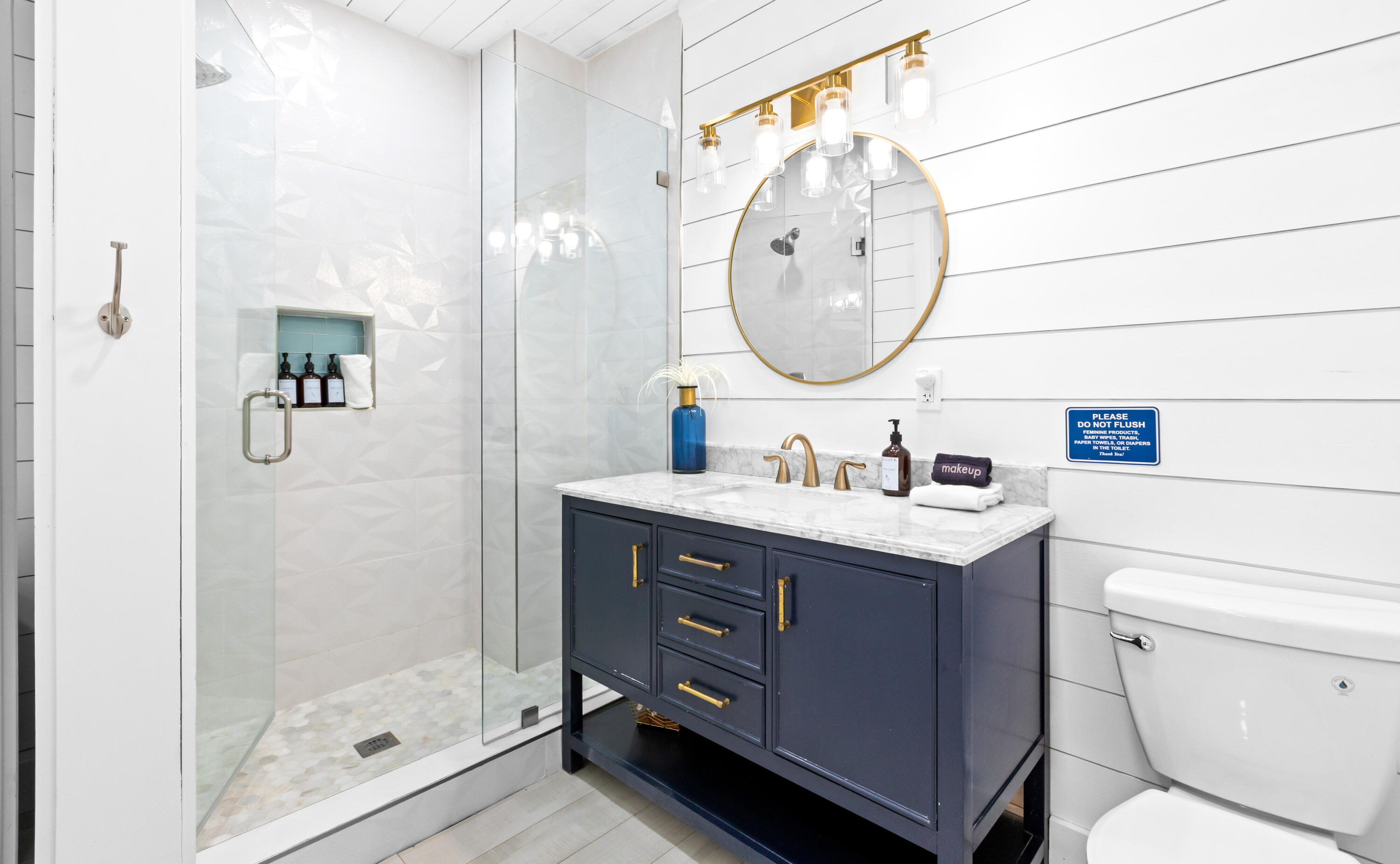 50 Maple Street Santa Rosa Beach, FL 32459 - Photo 28 of 60 a bathroom with a sink vanity mirror and toilet