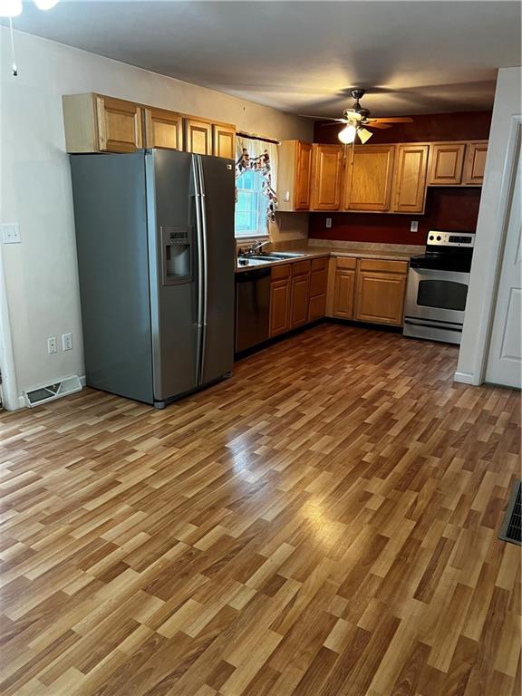 416 Ranch Road Dunbar, PA 15431 - Photo 6 of 25 a kitchen with granite countertop a refrigerator and a stove top oven
