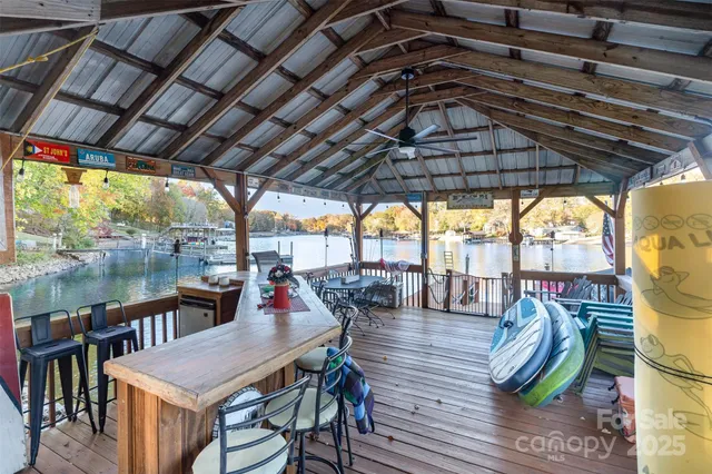 a view of a brick house with large windows and a tree