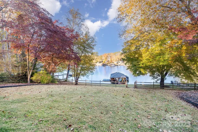 a view of a yard with a house and a table and chairs