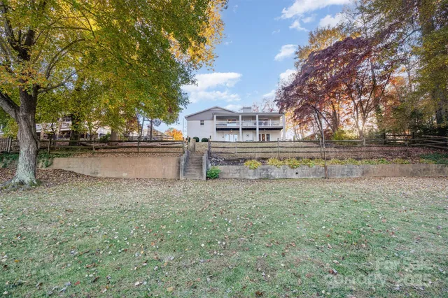 a view of a balcony with chairs and wooden floor