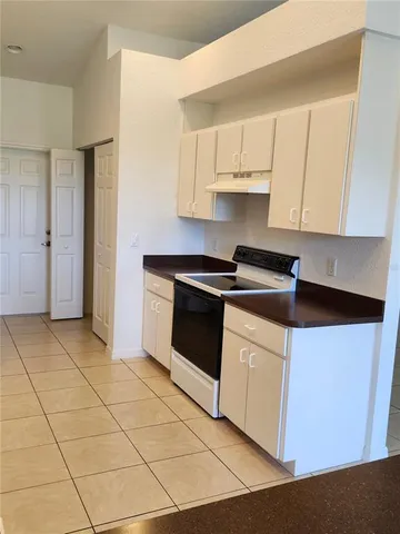 a kitchen with cabinets and appliances