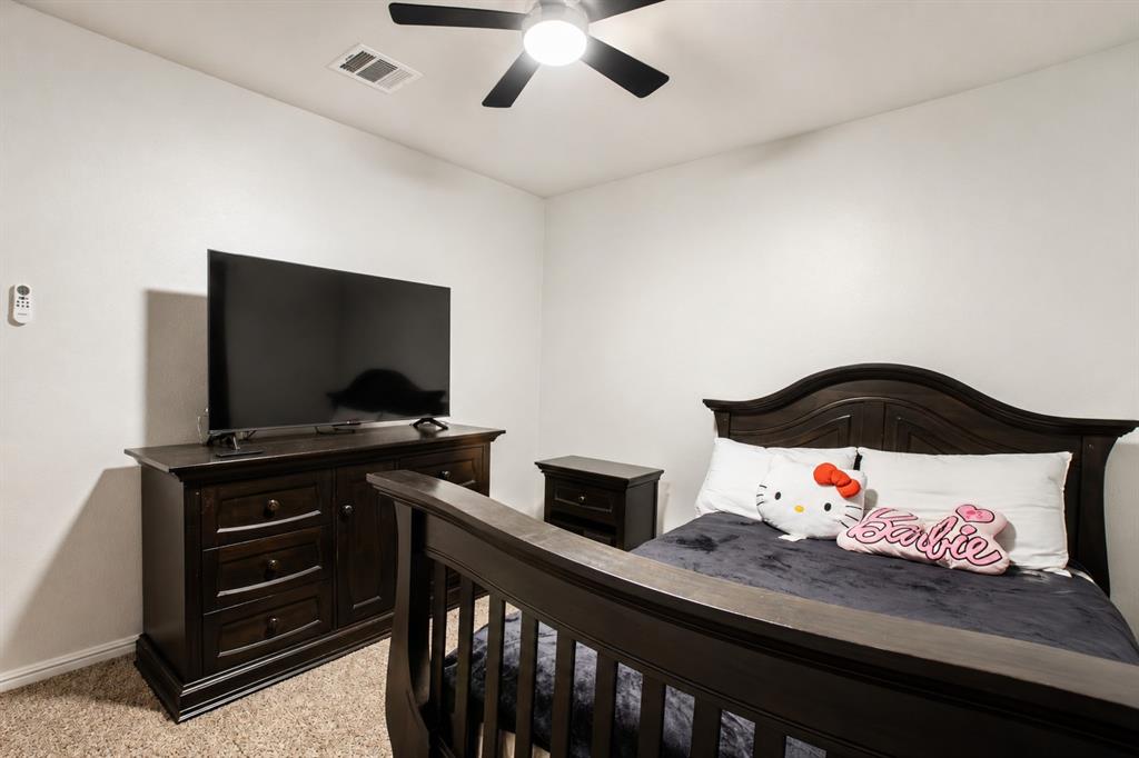 3204 Quiet Valley Road Fort Worth, TX 76123 - Photo 7 of 29 a bedroom with a bed and a flat screen tv