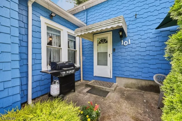 a view of entrance of the house with potted plants