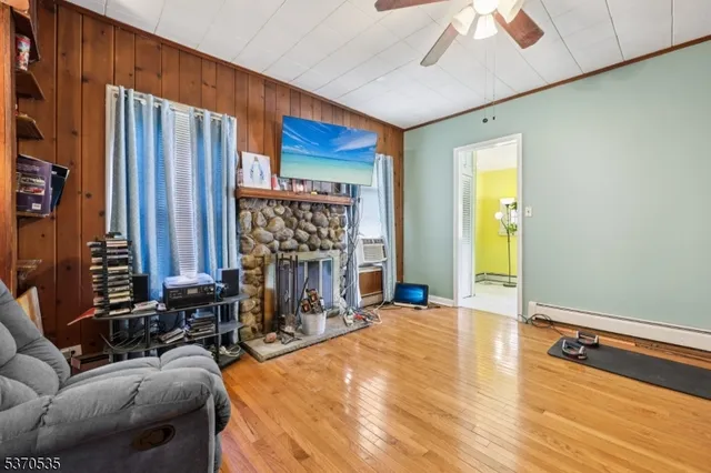 a living room with fireplace furniture and a window