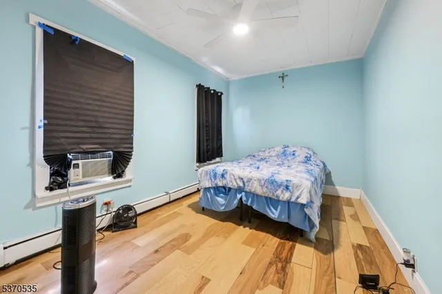 a bedroom with a bed and a flat tv screen on the dresser