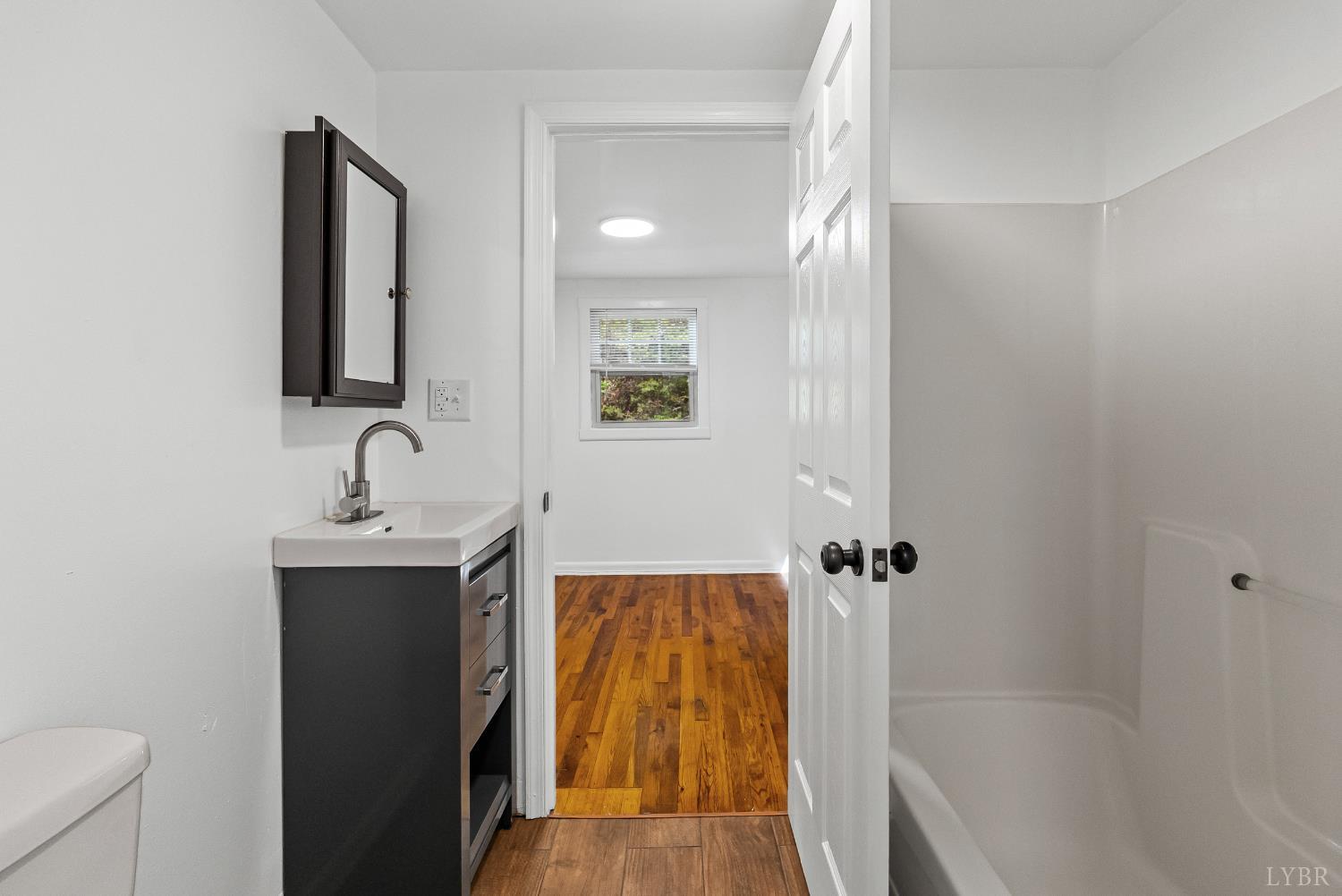2758 Allens Creek Road Gladstone, VA 24553 - Photo 13 of 25 a bathroom with a sink a toilet and shower